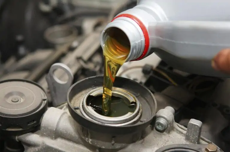 A tense moment as a person fights against time to save their overheating car engine. With a bottle of oil in hand, they pour it in, hoping to cool down the engine before it's too late.