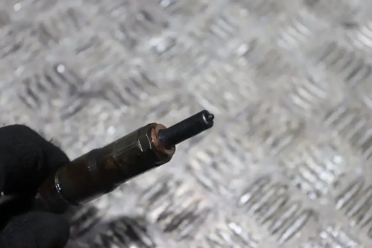 A mechanic investigates a heavily clogged air filter, unveiling a potential engine issue. The close-up view reveals the filter's dirt-filled crevices, emphasizing the need for immediate attention.