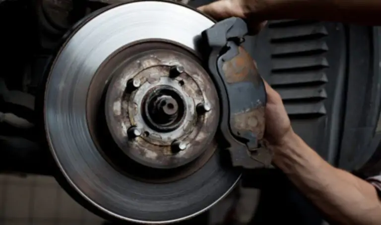 In a well-equipped garage, a skilled mechanic meticulously adjusts the brake pads of a car to ensure optimal performance. Explore the importance of routine brake maintenance and the expertise required to keep vehicles safe on the road.