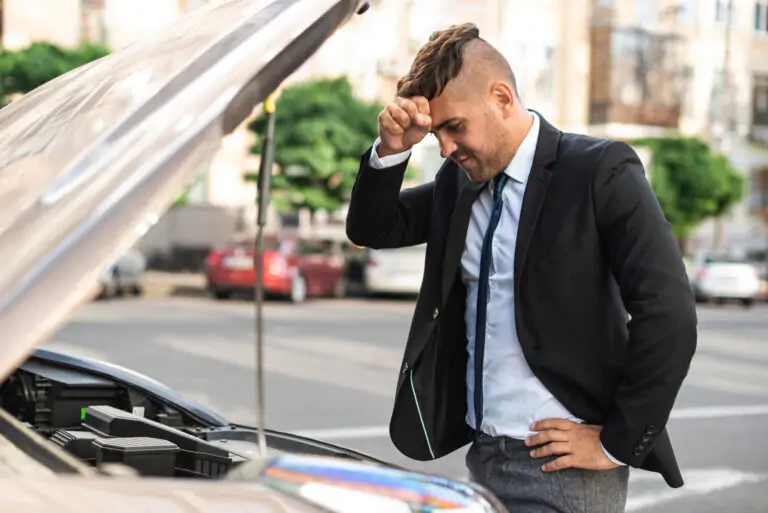 A man in a suit intently inspects the open hood of a car, searching for answers to a mechanical issue. Explore the challenges of diagnosing common car problems and the expertise required to keep vehicles running smoothly on the road.