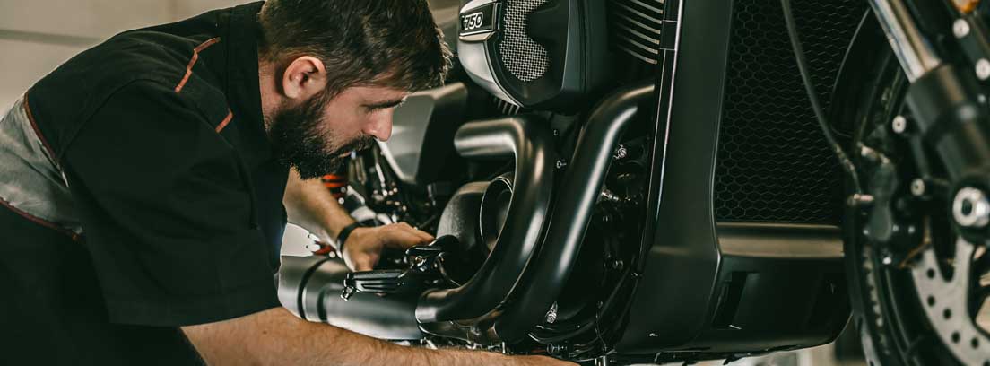 Mechanic changing oil for motorcycle