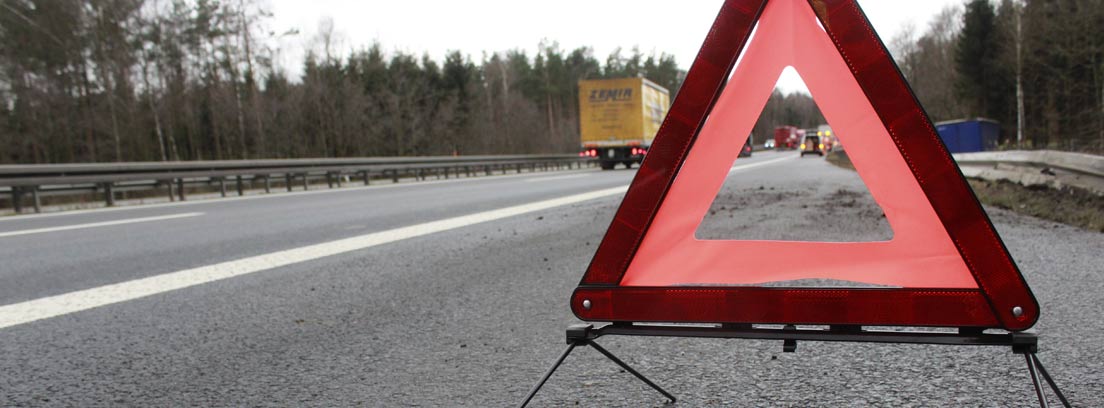 Broken down car warning triangle on a road