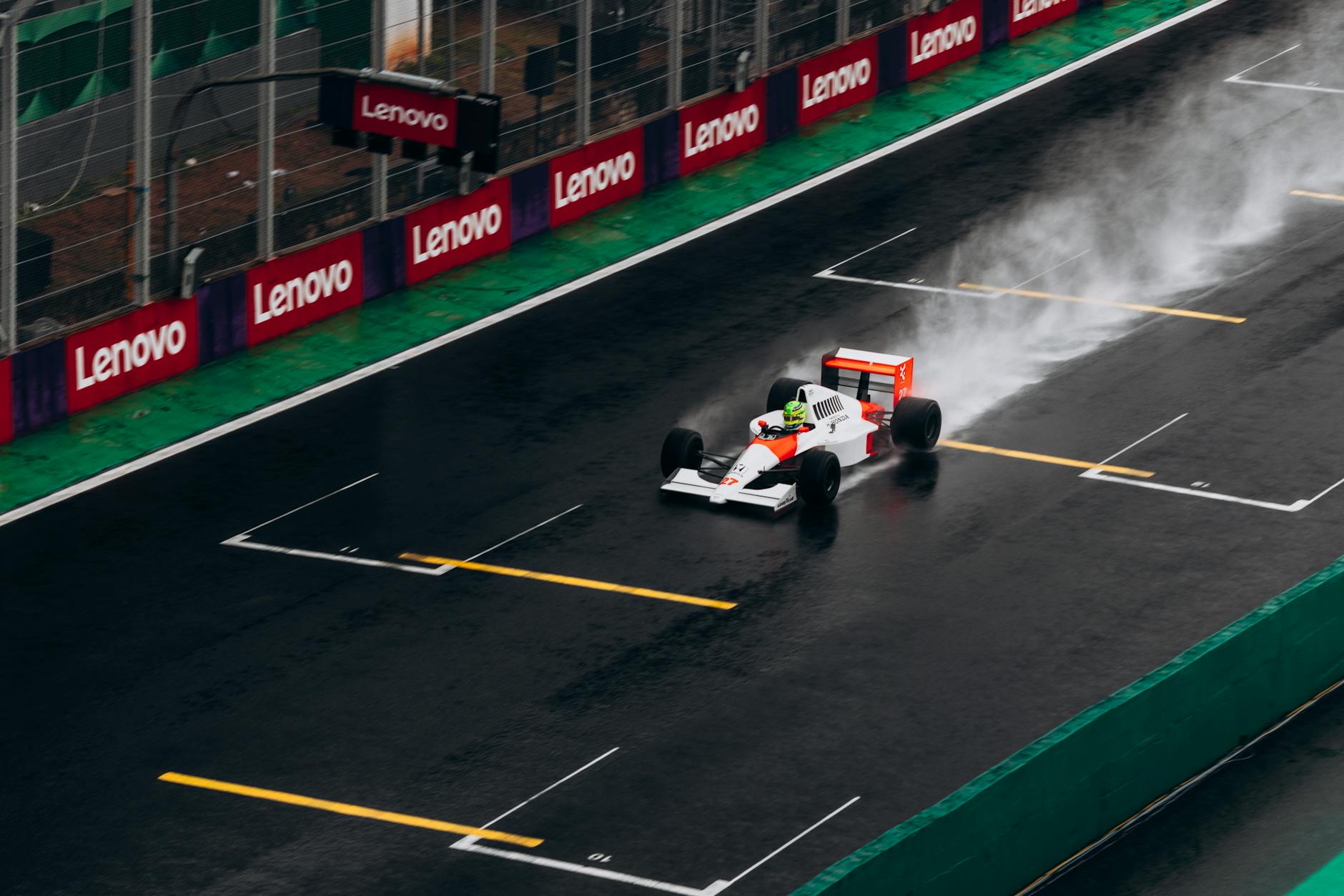 https://www.pexels.com/photo/racing-car-on-wet-track-at-speed-29283587/